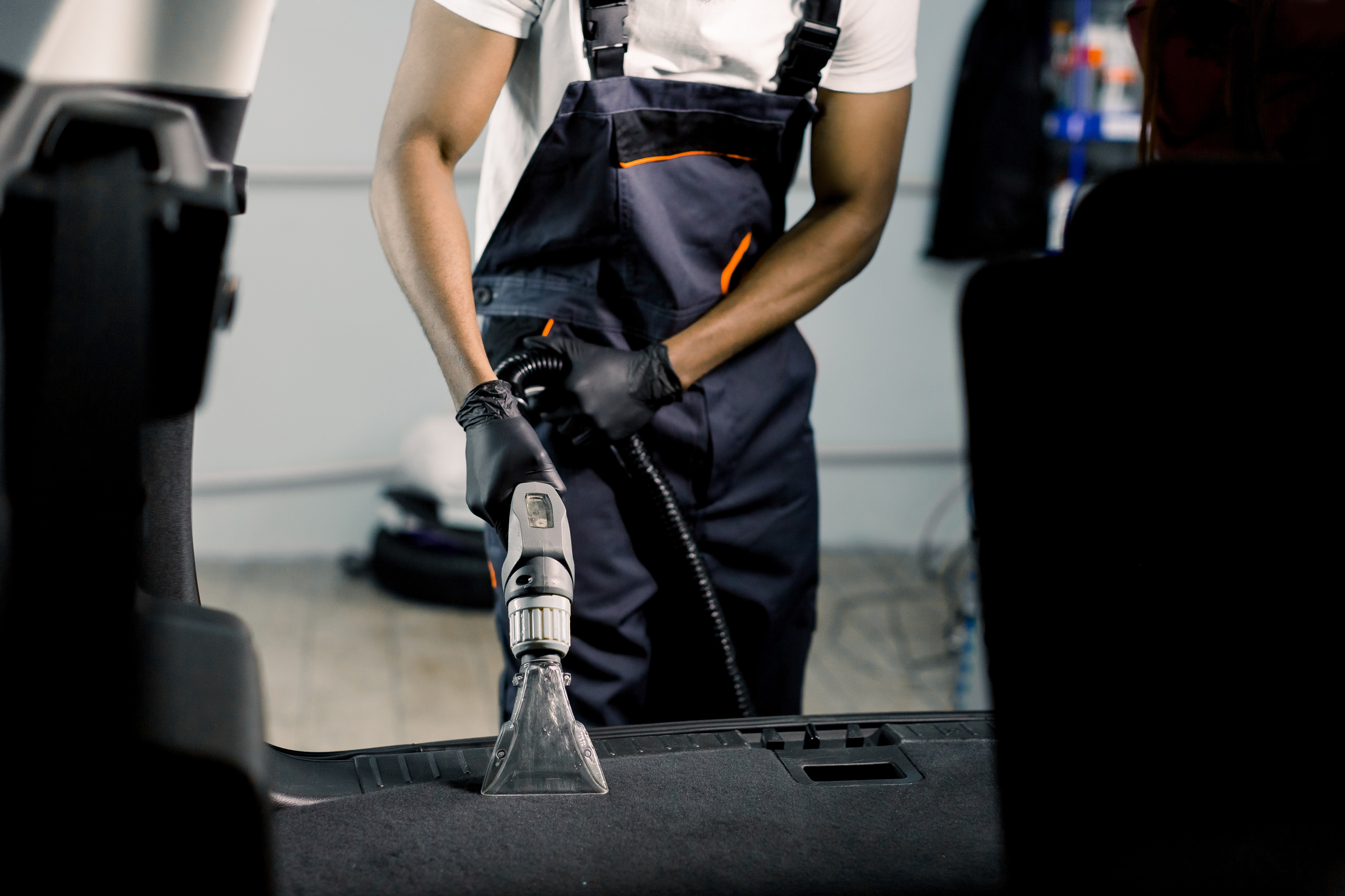 Guy Vacuuming Out Interior of Car